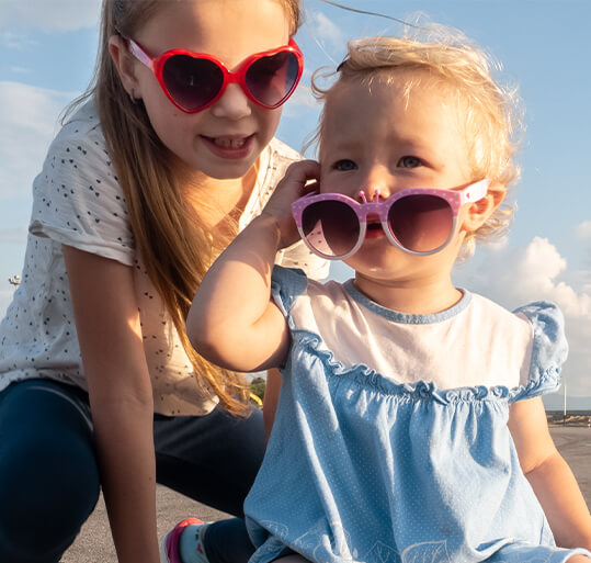Two young girls wearing sunglasses
