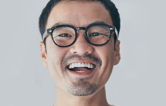 A smiling man in glasses