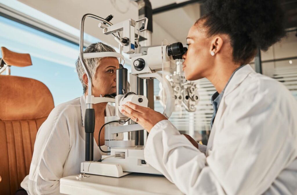 A senior woman having her eyes checked for cataracts and glaucoma by an optometrist.