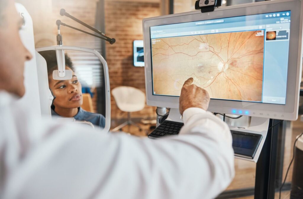 An eye doctor reviews a tomography scan with his patient after an eye exam.